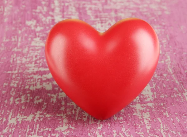 Decorative red heart on color wooden background — Stock fotografie