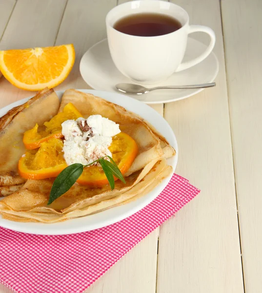 Pancakes with orange on bright background — Stock Photo, Image