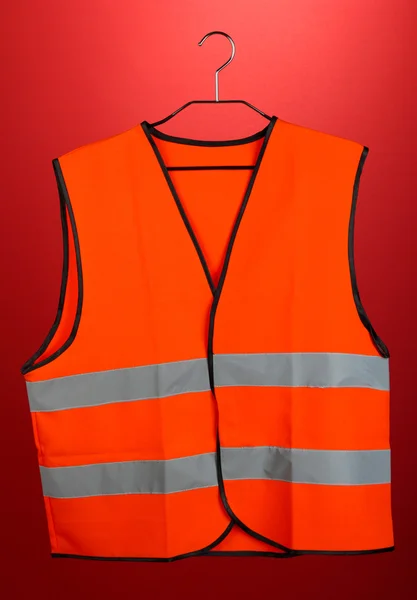 Orange vest, on color background — Stock Photo, Image