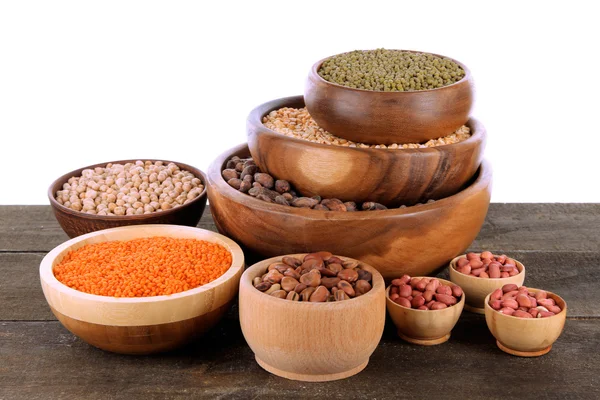 Different kinds of beans in bowls on table isolated on white — Stock Photo, Image