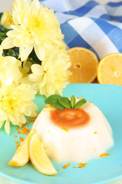 Lemon Panna Cotta with orange zest and caramel sauce, on color wooden background — Stock Photo, Image