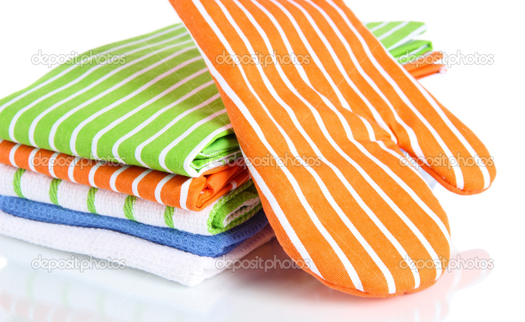 Orange potholder and stack of kitchen towels isolated on white
