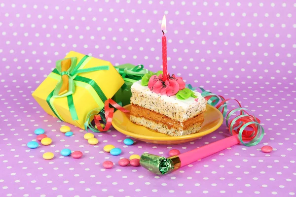 Colorful birthday cake with candle and gifts on pink background — Stock Photo, Image