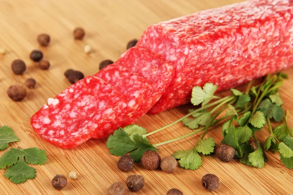 Välsmakande salami på träplatta närbild — Stockfoto