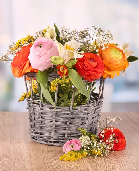 Many different flowers in basket on room background — Stock Photo, Image