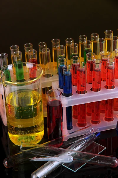 Colorful test tubes on dark background — Stock Photo, Image