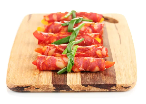 Salami rolls on wooden board, isolated on white — Stock Photo, Image