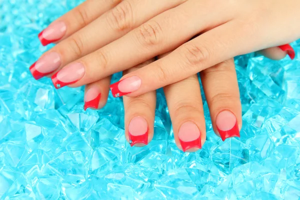 Closeup of hands of young woman with elegance manicure on bright background — Stock Photo, Image