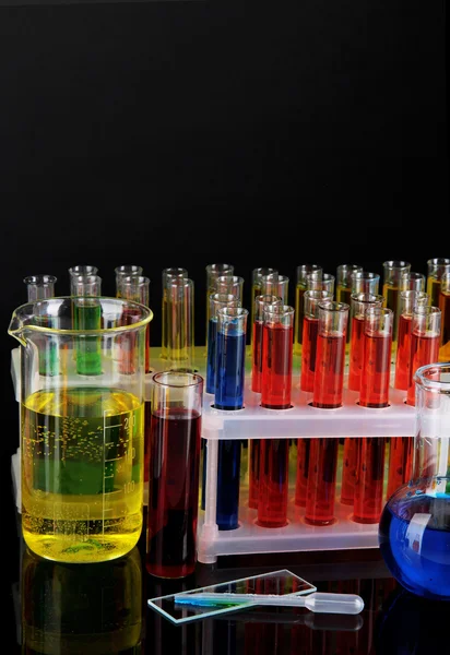 Colorful test tubes on dark background — Stock Photo, Image