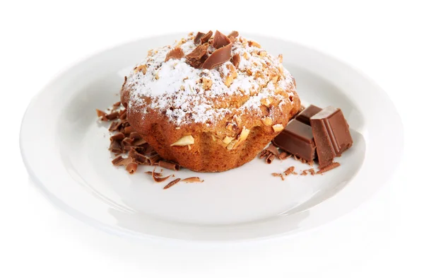 Tasty muffin cake with powdered sugar and chocolate on plate, isolated on white — Stock Photo, Image