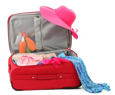 Suitcase with summer clothes, a hat and suntan isolated on white