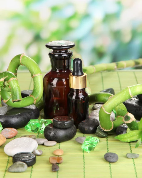 Spa composition with bamboo branches on wooden table on natural background — Stock Photo, Image