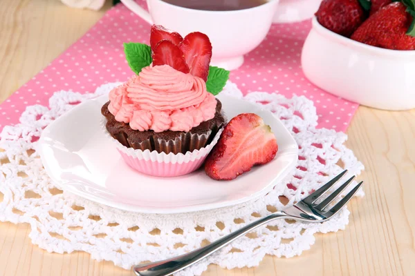 Beautiful strawberry cupcake on dining table close-up