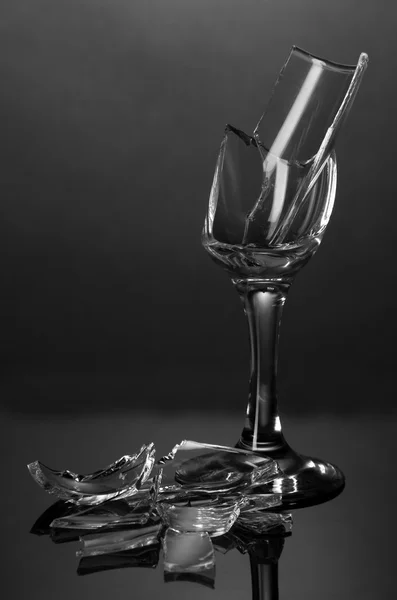 Broken wineglass on grey background — Stock Photo, Image