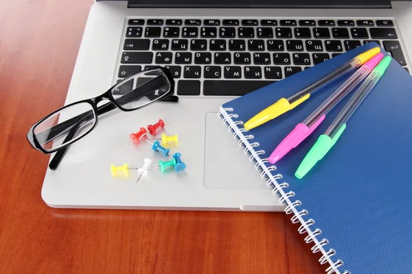 Laptop with stationery on table — Stock Photo, Image