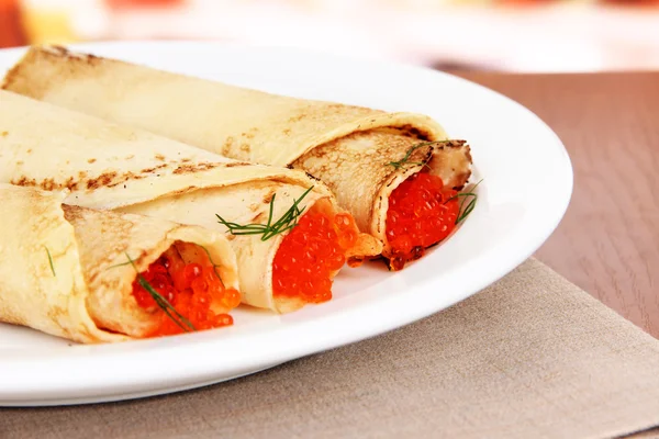 Delicious pancakes with red caviar on table in cafe — Stock Photo, Image