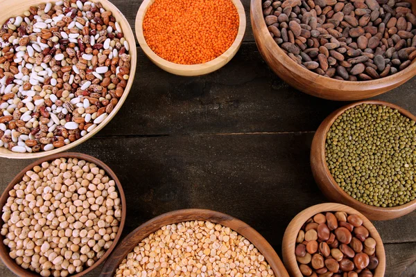 Different kinds of beans in bowls on table close-up — Stock Photo, Image