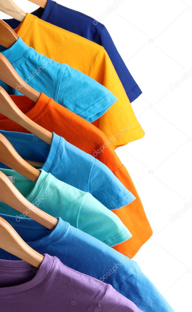 Lots of T-shirts on hangers isolated on white