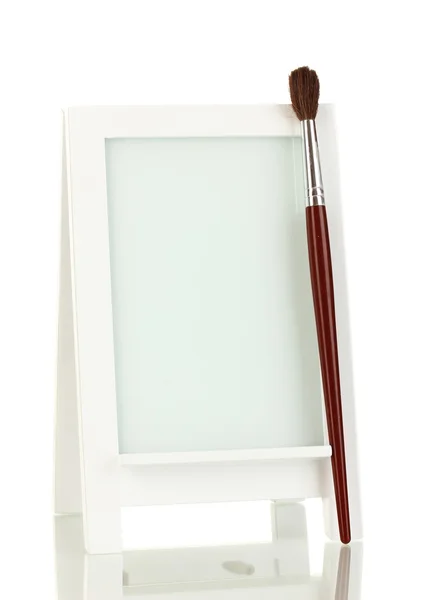 Photo frame as easel with brush isolated on white — Stock Photo, Image