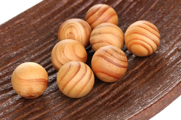 Wooden balls in decorative plate close-u — Stock Photo, Image
