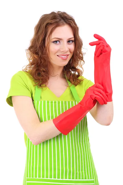 Young woman wearing green apron and rubber gloves, isolated on white — Stock Photo, Image