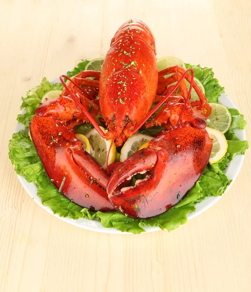 Red lobster on platter with vegetables on wooden table close-up — Stock Photo, Image