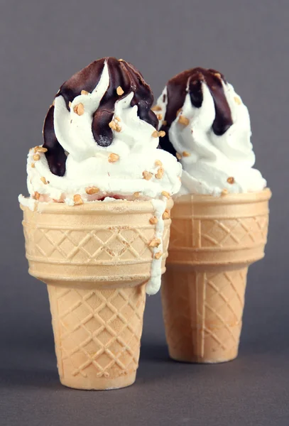 Tasty ice cream with chocolate, on grey background — Stock Photo, Image