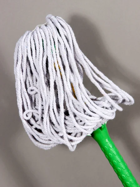 Mop for floor on gray background — Stock Photo, Image