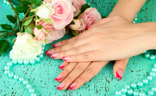 Closeup of hands of young woman with elegance manicure, on color background — Stock Photo, Image