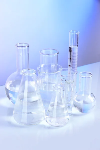 Test tubes on blue background — Stock Photo, Image