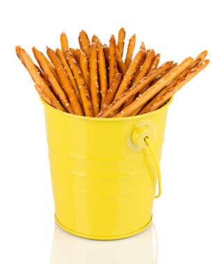 Tasty crispy sticks in yellow pail isolated on white