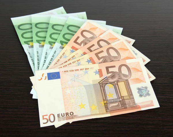 Euro banknotes on wooden background — Stock Photo, Image