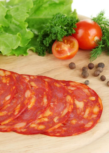 Salami slices on wooden board, close up — Stock Photo, Image