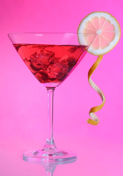 Red cocktail in martini glass on pink background — Stock Photo, Image