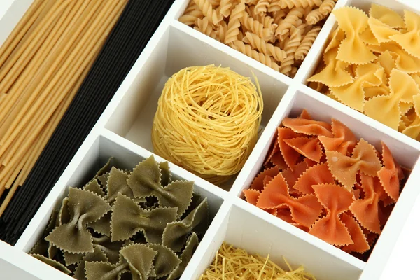 Different types of pasta in white wooden box sections close-up — Stock Photo, Image