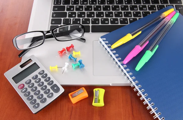 Laptop with stationery on table — Stock Photo, Image