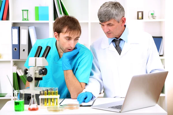 Physician and assayer during research on room background — Stock Photo, Image