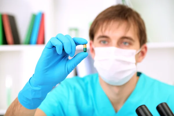 Assayer during research on room background — Stock Photo, Image