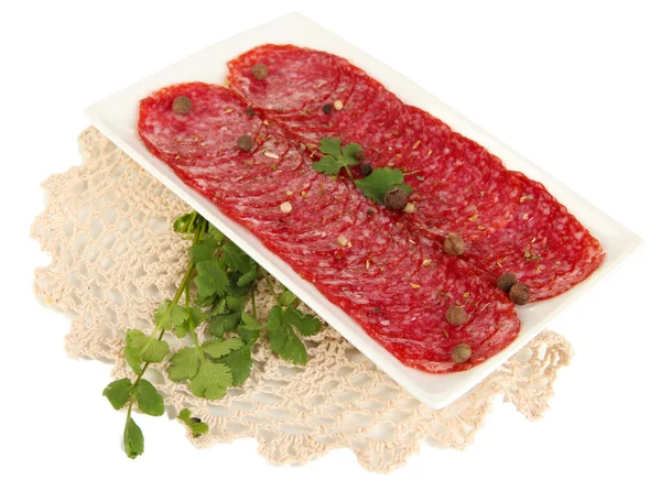Sabroso salami en plato en servilleta aislado en blanco —  Fotos de Stock