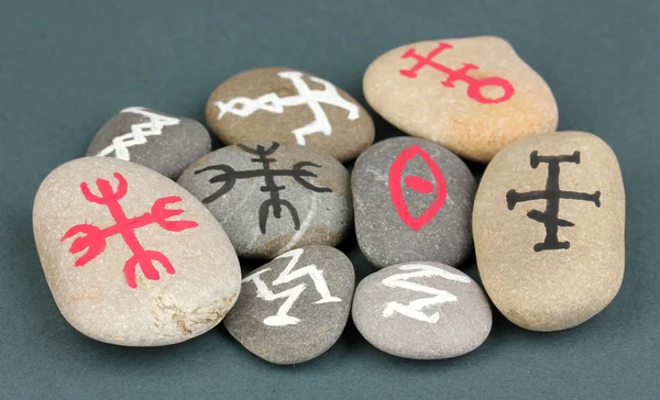 Fortune telling with symbols on stones on grey background — Stock Photo, Image