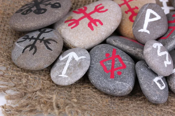 Fortune telling with symbols on stones on burlap background — Stock Photo, Image