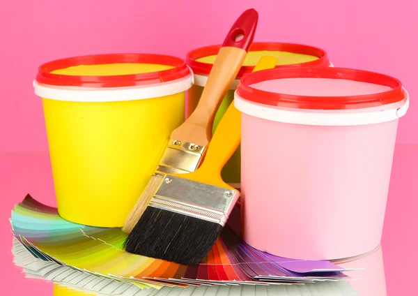 Set for painting: paint pots, brushes, palette of colors on pink background — Stock Photo, Image