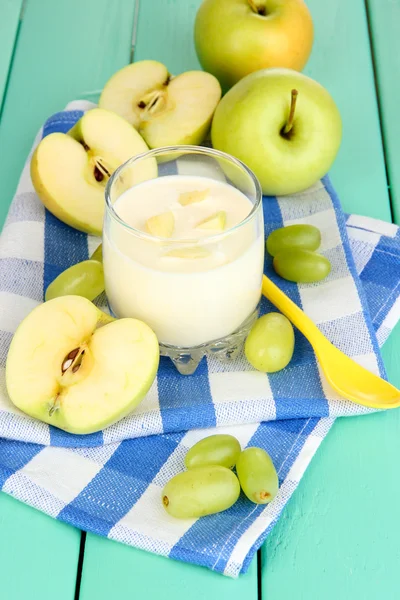 Delicious yogurt in glass with fruit on wooden table close-up — Stock Photo, Image
