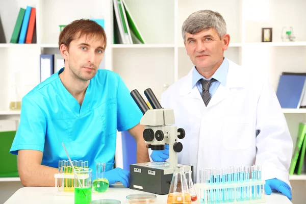 Physician and assayer during research on room background — Stock Photo, Image