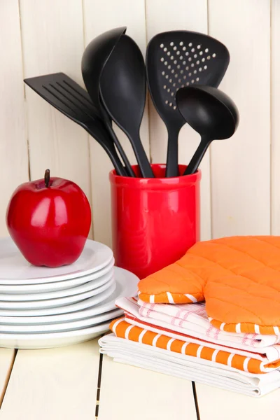 Ajustes de cocina: utensilios, agarraderas, toallas y más en la mesa de madera —  Fotos de Stock