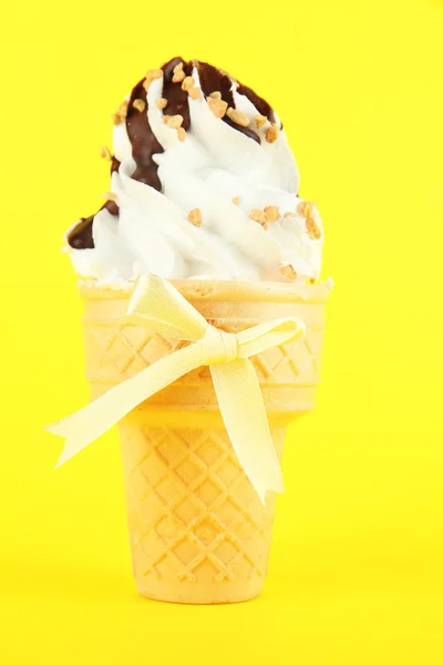 Tasty ice cream with chocolate, on yellow background — Stock Photo, Image