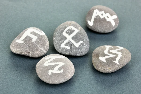 Fortune telling with symbols on stones on grey background — Stock Photo, Image
