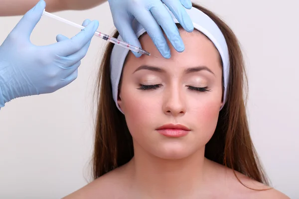 Young woman receiving plastic surgery injection on her face close up — Stock Photo, Image