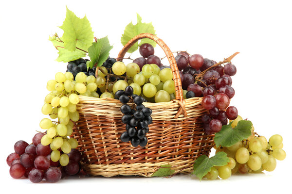 assortment of ripe sweet grapes in basket, isolated on whit