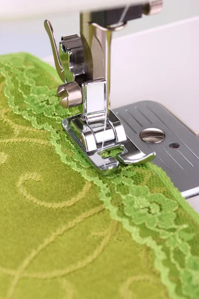 Closeup of sewing machine working part with green cloth — Stock Photo, Image